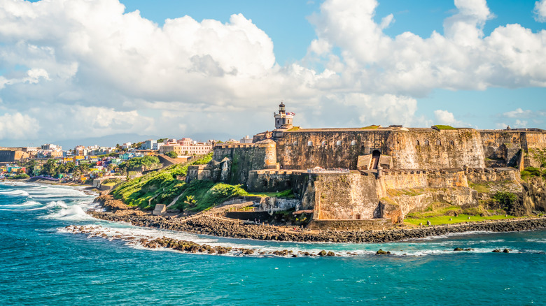 Aerial view of of Puerto Rico island with an historical castle on the rugged coastline
