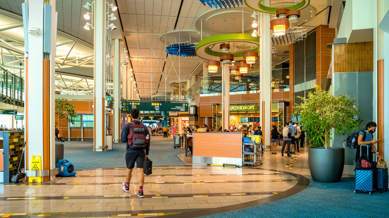 Man walks inside Vancouver International Airport Terminal in Vancouver, Canada on a sunny day