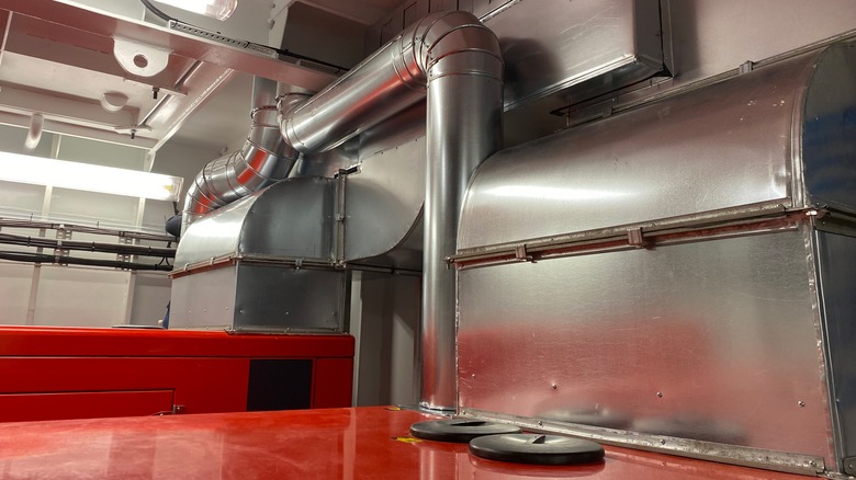 Ship engine room with generators and HVAC duct piping