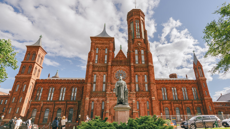 The Smithsonian Institution's red building with a statue in front