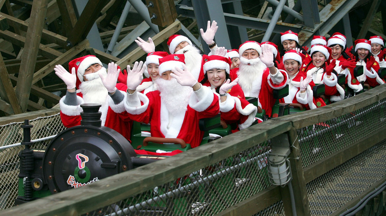 Korean tourists wearing Santa Claus suits riding the Monimo Rush wooden roller coaster at South Korea's Everland amusement park