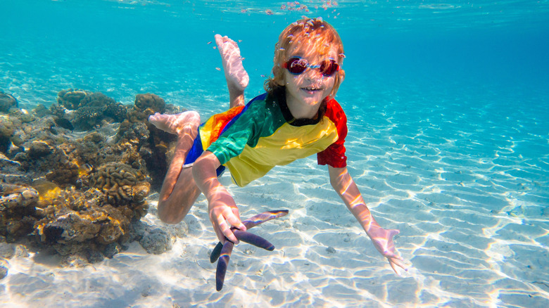Child snorkels with starfish