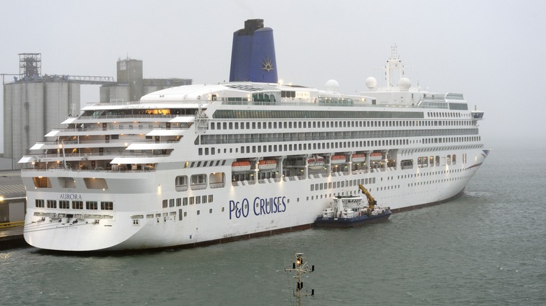View of the P&O Aurora cruise ship taking on fuel in grey misty weather
