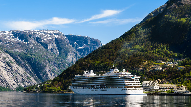 Viking Sun ship sailing through Norwegian mountains and fjords on a sunny day