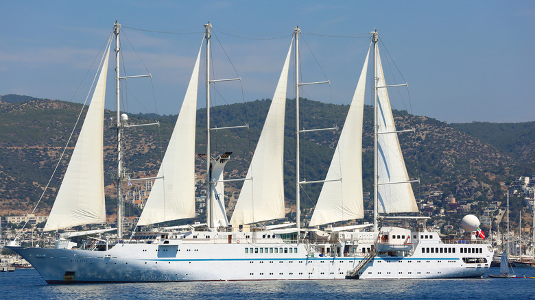 Windstar's Wind Surf sailing yacht departs port on a sunny day