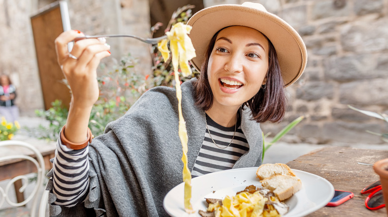 woman enjoying pasta