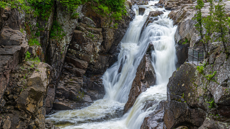 A waterfall cascades over rocks at High Falls Gorge
