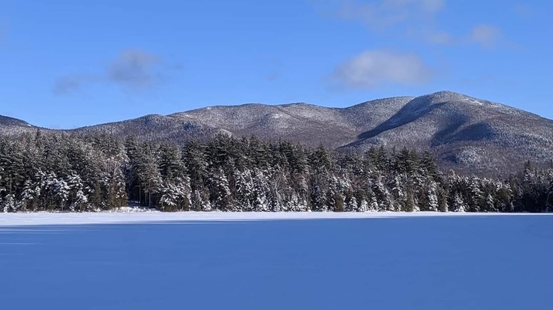 Snow-covered Heart Lake with pine-forested mountains in the background