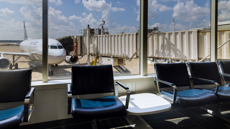 View of waiting chairs with airplane in the background at the George Bush Intercontinental Airport