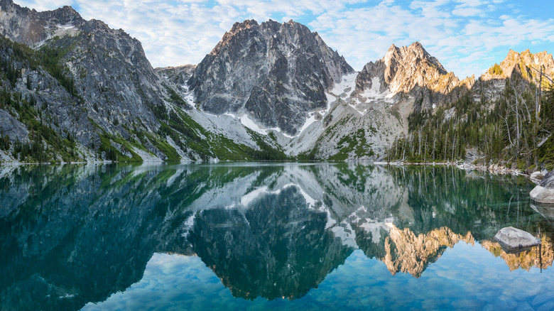 Sunrise illuminates Dragontail Peak and Asgaard Pass above the turquoise waters of Colchuck Lake.
