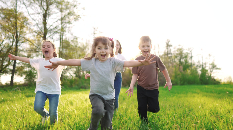 Kids running through the grass