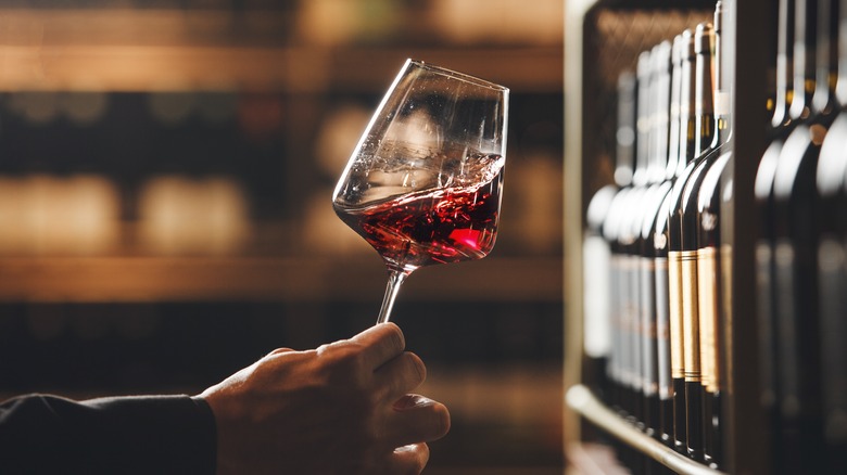 Someone holding a glass of red wine