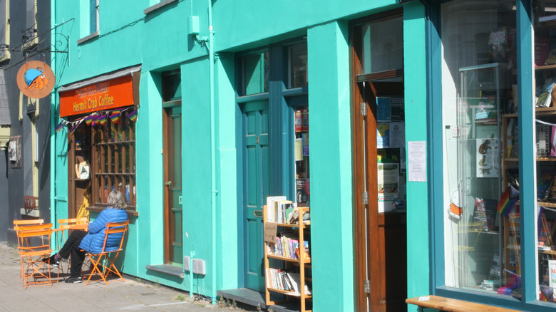 A person sits outside a coffee shop in Machynlleth