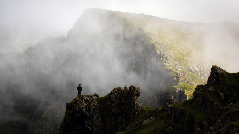 A hiker on a crag on Cadair Idris, the mountain just north of Machynlleth