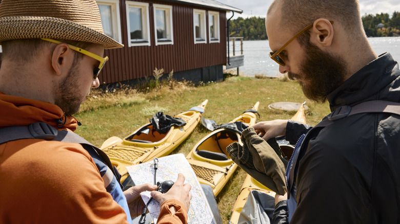 Paddlers checking a map before trip
