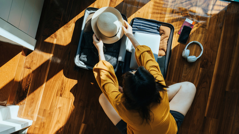 A person packing luggage