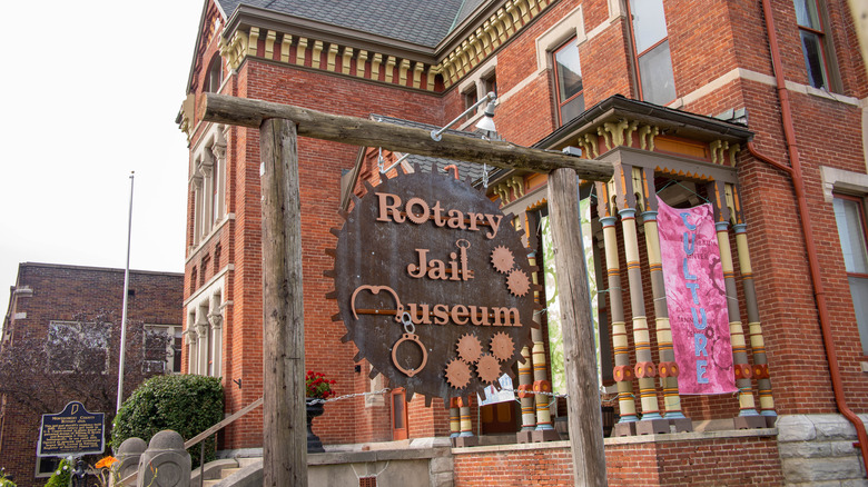 Exterior of the Rotary Jail Museum, with a rotary-themed sign, in Crawfordsville