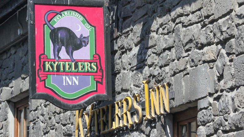 Closeup of Kyteler's Inn sign outside of stone building