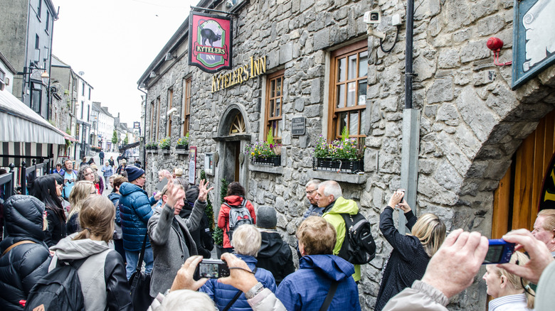Kyteler's Inn from the street with a crowd of tourists taking photos