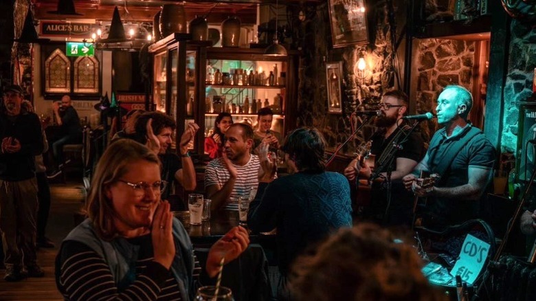 Patrons at Kyteler's Inn clapping and smiling during live music performance