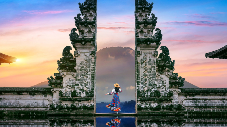 Woman stands between Gates of Heaven at Lempuyang Temple