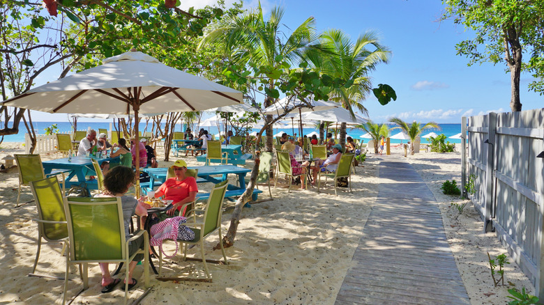 People hanging out at outdoor tables in Meads Bay, Anguilla