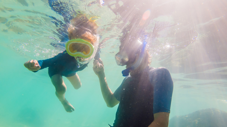 Man and boy snorkeling underwater