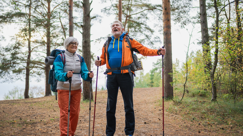 mature couple, in hiking gear in the woods