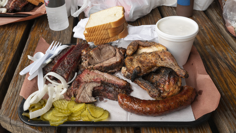 BBQ plate on a tray with sausage, chicken and brisket