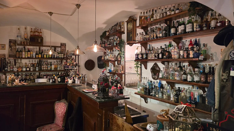 Numerous liquor bottles on display behind the bar at Bohème Mixology Bar, Catania, Sicily