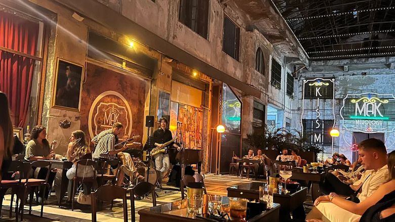 Musicians play live in the large warehouse-like space of Mak Mixology in Palermo, Sicily
