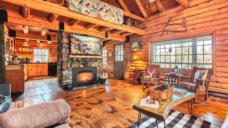 Wood living room with fireplace inside cabin