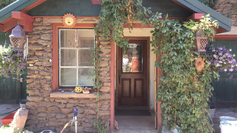 Stone house covered in vines