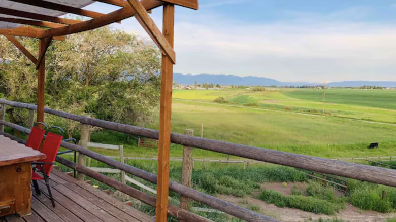 Front porch view looking out onto green field
