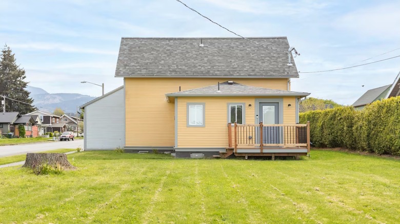 Yellow Cottage with mountains in the backbround