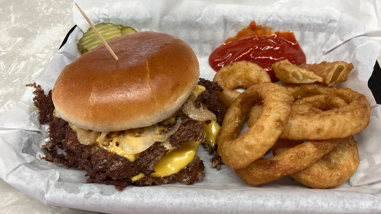 Cheeseburger with sauteed onions and side of onion rings from the Workingman's Friend