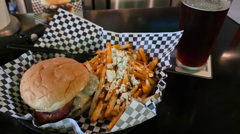 Cheeseburger and buffalo fries with blue cheese, and a dark beer from JL Beers