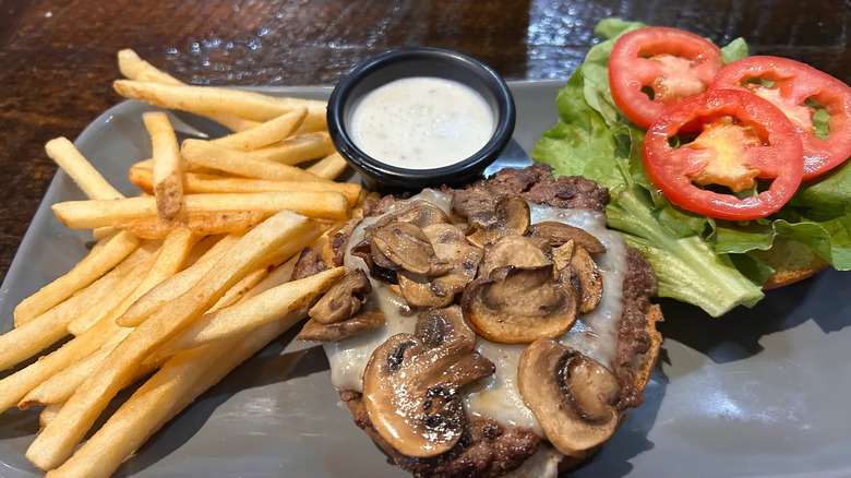 Mushroom cheeseburger with side of fries, ranch, and lettuce and tomato from Black Hills Burger & Bun Co.