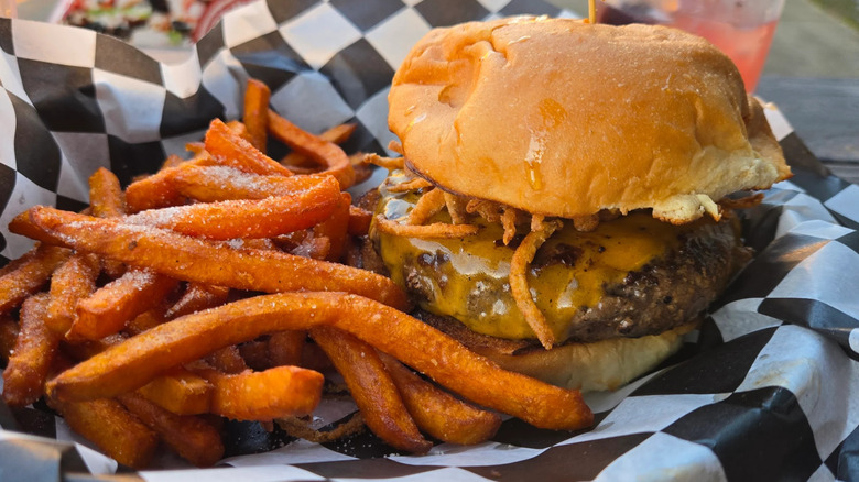 Cheeseburger with fried onion and sweet potato fries from Repeal Bourbon & Burgers