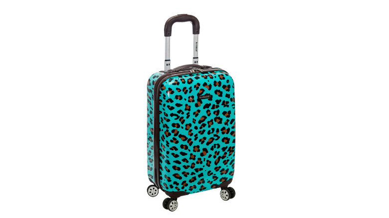 Violently turquoise-coloured luggage with a leopard-skin pattern on a white background