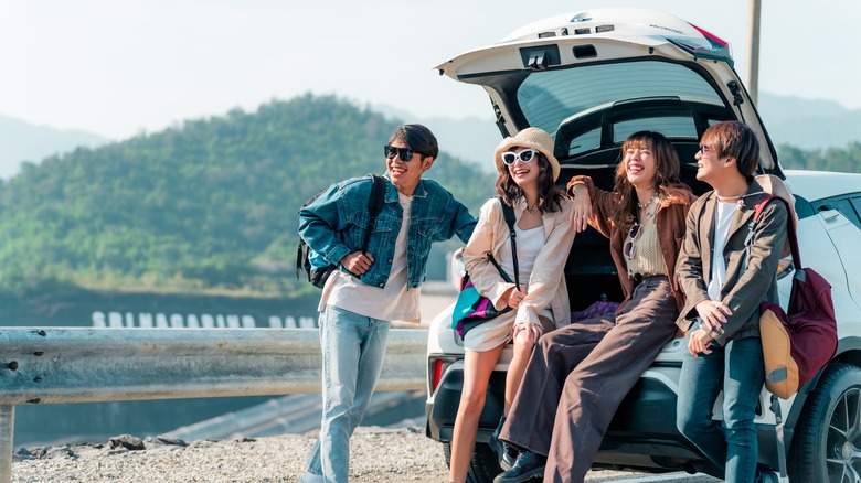 Group of women traveling with a car