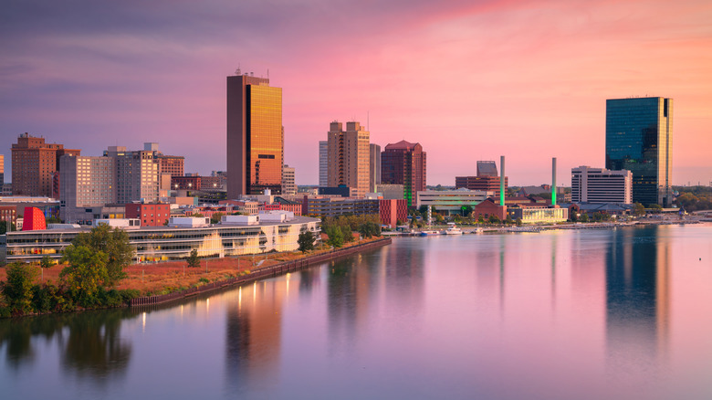 Aerial view of downtown Toledo, Ohio, with the skyline reflected in the Maumee River at sunrise