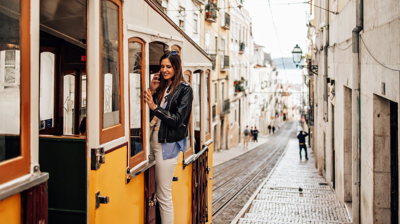 Woman riding trolley in Lisbon, Portugal