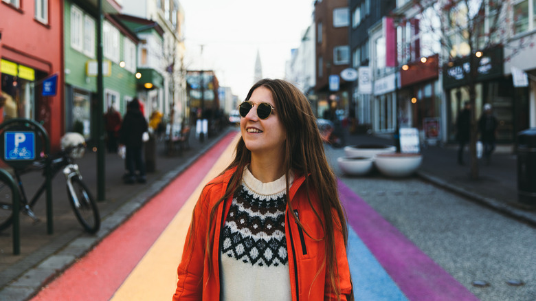 Woman on rainbow crosswalk in Reykjavik, Iceland