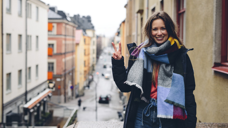 Woman with peace sign in Stockholm, Sweden