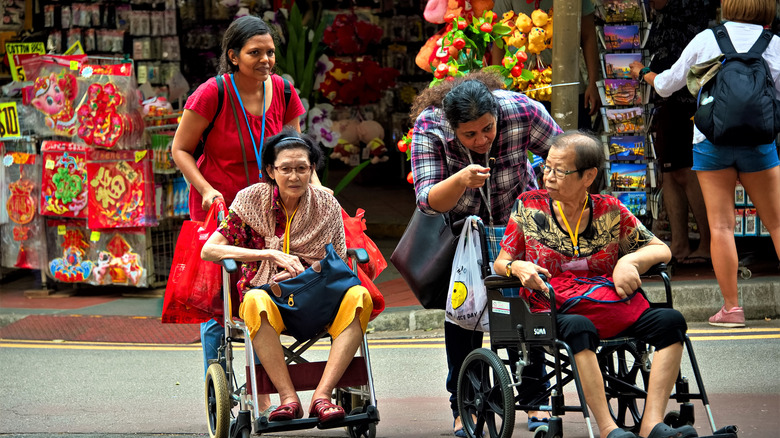 two elderly ladies in wheelchairs in Sinagpore