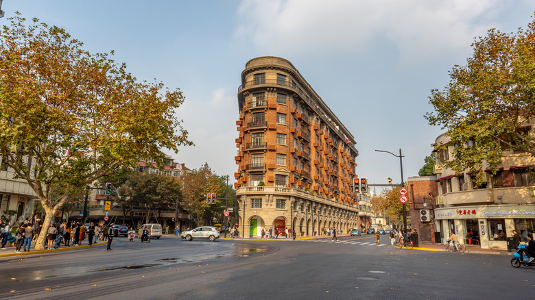 French Renaissance-style building in the middle of crossroads surrounded by plane trees
