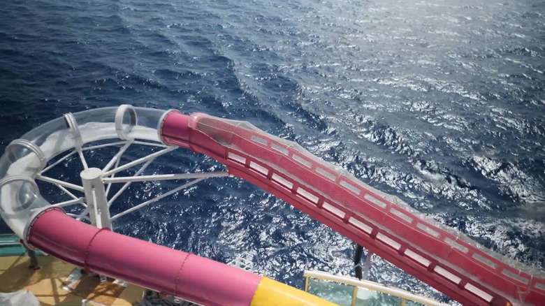 Transparent and pink water tube and blue waters in the backdrop on a Royal Caribbean ship