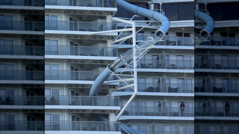 Semi transparent, winding water tube next to the rising stories of the NCL Prima ship