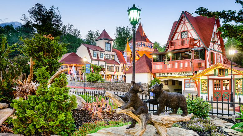 Statues of two bears in Helen, Georgia, with Bavarian buildings in the background